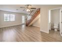 Spacious living room with wood-look flooring, bright windows, and staircase access at 5330 E Charleston Blvd # 28, Las Vegas, NV 89142
