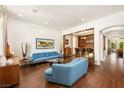 Open-concept living room features hardwood floors, white walls, recessed lighting, and a built-in bar area for entertaining at 5850 Rockway Glen Ave, Las Vegas, NV 89141