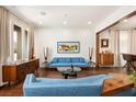 Spacious living room features hardwood floors, natural light, recessed lighting, and tasteful mid-century modern furniture at 5850 Rockway Glen Ave, Las Vegas, NV 89141