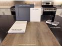Kitchen finishes showcasing luxury vinyl plank flooring, grey cabinets, and white counter tops for a modern aesthetic at 5941 Violet Crown St, North Las Vegas, NV 89081