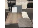 Kitchen finishes featuring luxury vinyl plank flooring, grey cabinets and white counter tops, offering a modern touch at 5941 Violet Crown St, North Las Vegas, NV 89081