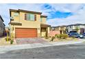 Two-story home showcasing a landscaped front yard and a two-car garage at 6046 Castle Gardens Ave, Las Vegas, NV 89130