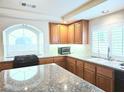 Well-lit kitchen featuring wooden cabinets, granite countertops, and stainless steel appliances at 6269 Bold Regatta Ct, Las Vegas, NV 89139