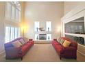 Spacious living room featuring a fireplace, high ceilings, and bright natural light at 6269 Bold Regatta Ct, Las Vegas, NV 89139