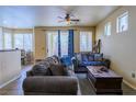 Inviting living room with tile floor, sliding glass doors to the back yard, and neutral paint at 6279 Dollar Bill Ct, Las Vegas, NV 89141