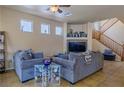 Comfortable living room featuring tile floors, staircase, and a ceiling fan at 6279 Dollar Bill Ct, Las Vegas, NV 89141