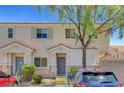 Charming townhouse exterior with well-kept landscaping and inviting entrance at 6433 Buck Jones Ave # 102, Las Vegas, NV 89122