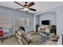 Comfortable living room with a ceiling fan, natural light and a cozy seating area at 6433 Buck Jones Ave # 102, Las Vegas, NV 89122