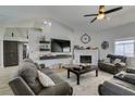 Bright living room features high ceilings, a cozy fireplace, and comfortable seating, perfect for relaxation at 6517 W Brooks Ave, Las Vegas, NV 89108