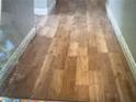 A room with hardwood floors needing some repairs at 6531 Goldfield St, North Las Vegas, NV 89084
