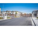 Gated community entrance with modern metal gates and well-maintained landscaping, ensuring privacy at 7003 Crimson Shadow St, North Las Vegas, NV 89086
