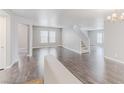 Bright, open-concept living room with dark wood floors and neutral paint at 776 Anacapri St, Las Vegas, NV 89138