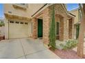 Inviting front exterior with stone facade, desert landscaping, and attached one-car garage at 8261 Golden Flowers St, Las Vegas, NV 89139