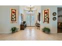 Elegant foyer showcases decorative sconces, neutral tile flooring, and double door entry at 8325 Villa De Medici St, Las Vegas, NV 89131