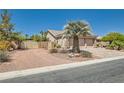 Beautiful landscaped front yard with a palm tree, desert landscaping and gated RV or boat parking at 8325 Villa De Medici St, Las Vegas, NV 89131