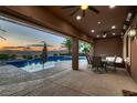 Relaxing covered patio with outdoor dining area and view of the pool, perfect for entertaining at 8705 Killians Greens Dr, Las Vegas, NV 89131