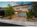 Charming two-story home with manicured front yard, paver driveway, and a spacious two car garage at 881 Cherry Glen Pl, Las Vegas, NV 89138
