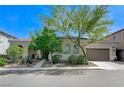 Attractive single-story home with a tile roof, arched windows, and a convenient two-car attached garage at 9243 White Waterfall Ave, Las Vegas, NV 89149