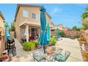 An outdoor patio showcases a shaded dining area with green plants and colorful décor, perfect for entertaining at 9412 Jewel Lake Ave, Las Vegas, NV 89166
