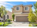 Attractive two-story home with a two-car garage and manicured lawn creates a welcoming ambiance at 9465 Perennial View Ave, Las Vegas, NV 89148