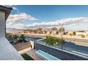 Tranquil backyard view featuring an outdoor water feature, minimalist landscaping, and neighborhood views at 9732 Abel Cliff St, Las Vegas, NV 89143
