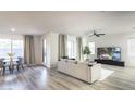 Open-concept living and dining area with modern furnishings and plenty of natural light at 9732 Abel Cliff St, Las Vegas, NV 89143
