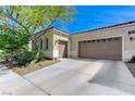 A spacious two-car garage and driveway are visible in this exterior shot with desert landscaping at , Las Vegas, NV 89149