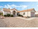 Inviting single-story home featuring desert landscaping, a tile roof, and a welcoming entrance at 10029 Netherton Dr, Las Vegas, NV 89134