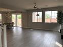 Bright living room with tile flooring, large windows, and access to the dining area and backyard at 1064 Blue Wine Ct, Henderson, NV 89002