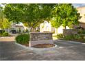 Landscaped community entrance with stone sign reading 'Kingsbarns Court' and lush greenery at 11830 Kingsbarns Ct, Las Vegas, NV 89141