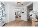 Bright foyer with hardwood floors, designer lighting, and views of the living and exercise rooms at 11830 Kingsbarns Ct, Las Vegas, NV 89141