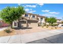 A two-story home featuring a three-car garage and well-maintained landscaping at 1291 Rolling Sunset St, Henderson, NV 89052