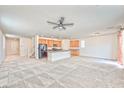 Bright living room featuring neutral carpet, fan and an open floor plan at 156 Fulgora St, Henderson, NV 89074