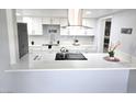Bright kitchen featuring white cabinets, modern appliances, and a stylish countertop island, perfect for meal preparation at 1836 Mcdaniel St, North Las Vegas, NV 89030