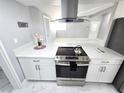 Modern kitchen featuring stainless steel appliances, white cabinetry, and marble-look flooring at 1836 Mcdaniel St, North Las Vegas, NV 89030