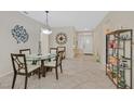 Bright dining area with a glass table and decorative wall art near the entry at 2103 Poppywood Ave, Henderson, NV 89012