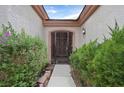 Inviting front entrance with a decorative wrought iron gate and lush greenery at 2103 Poppywood Ave, Henderson, NV 89012