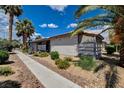 Cozy single-story home showcasing a landscaped front yard with beautiful palm trees at 227 N Lamb Blvd # B, Las Vegas, NV 89110