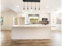 Bright kitchen with white cabinets, stainless steel appliances, and a large center island at 2505 Showcase Dr, Las Vegas, NV 89134