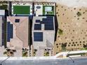 Aerial view of a home with solar panels, showcasing the backyard with a pool, spa, and well-maintained landscaping at 2601 Gallarate Dr, Henderson, NV 89044