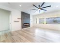 Bright living room featuring a modern fireplace, floating shelves, and large windows for natural light at 2651 Solera Moon Dr, Henderson, NV 89044