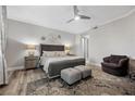 Cozy bedroom with plush rug, chair and ottomans, and en suite bathroom access at 30 Via Mantova # 109, Henderson, NV 89011