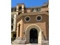 Stunning multi-story building with unique arched entry, round windows, and decorative lighting at 30 Via Mantova # 109, Henderson, NV 89011