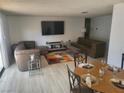 Open concept living and dining area with stylish furnishings and plenty of natural light at 3164 Elmrock Pl, Las Vegas, NV 89121