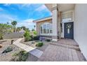 Inviting front entrance featuring a brick pathway and mature, landscaped greenery and trees at 3165 S Monte Cristo Way, Las Vegas, NV 89117