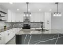 Modern kitchen with stylish waterfall island, stainless steel appliances, and ample cabinet space at 3905 Casa Grande Ave, Las Vegas, NV 89102