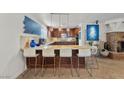 Bright kitchen featuring tile floors, custom cabinets, granite countertops and stainless steel appliances at 4185 W Arby Ave, Las Vegas, NV 89118