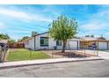 Charming one-story house featuring a well-manicured lawn and a chain-link fence-enclosed yard at 4432 Ash Ave, Las Vegas, NV 89110