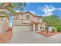 Two-story home with a well-maintained front yard, two-car garage, and a red tile roof at 4909 Cherokee Run Ct, Las Vegas, NV 89131