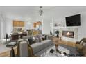 Open-concept living room and kitchen with hardwood floors and a fireplace at 4909 Cherokee Run Ct, Las Vegas, NV 89131